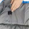 Fabric and hook-and-loop closure detail of grey down sleeping bag