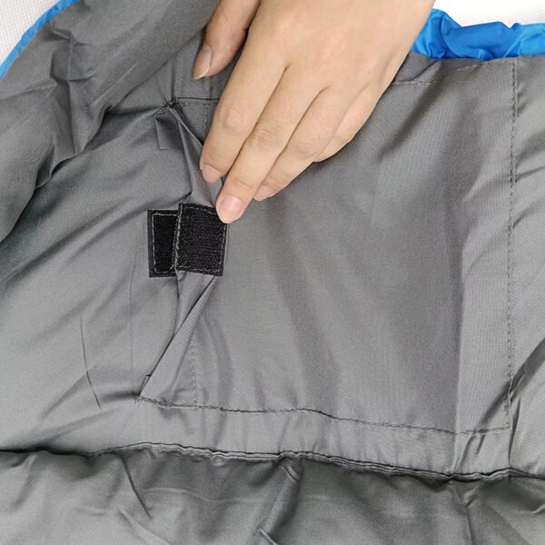 Fabric and hook-and-loop closure detail of grey down sleeping bag