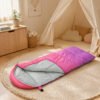 kids-sleeping-bag-indoor-use Pink and purple kids sleeping bag in a children's bedroom