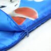 kids-sleeping-bag-zipper-detail Close-up of blue kids cartoon sleeping bag with zipper and printed design