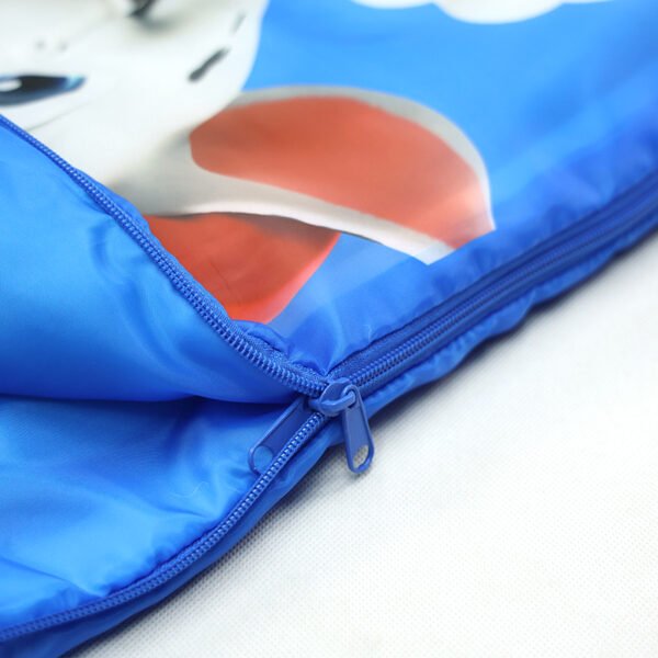 kids-sleeping-bag-zipper-detail Close-up of blue kids cartoon sleeping bag with zipper and printed design